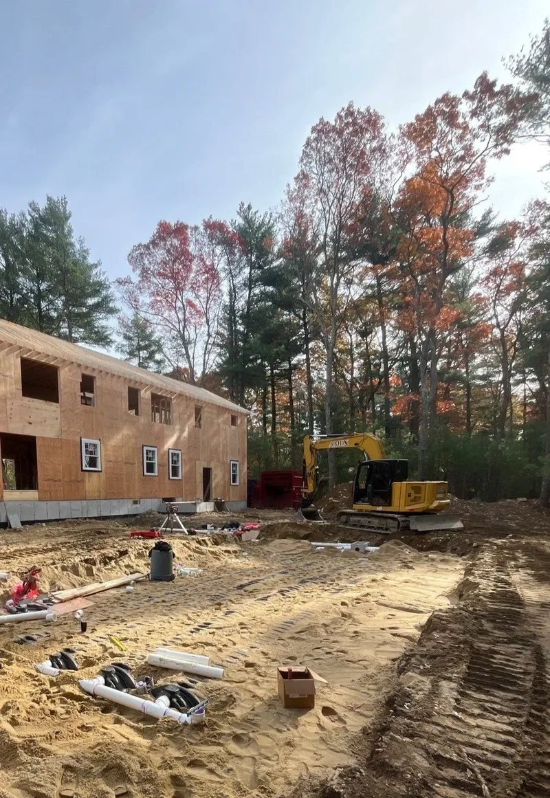 Septic system installation next to new residential framing