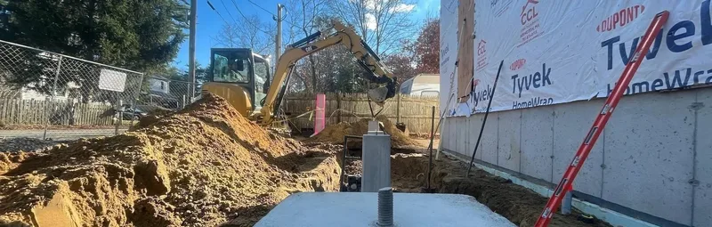 Foundation excavation adjacent to new home construction